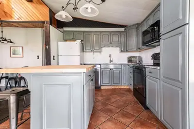 a kitchen with gray cabinets and a counter top at Waterfront Stagshead Lakehouse at Lake Arrowhead in Arrowhead Lake
