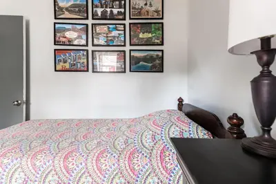 a bedroom with a bed and pictures on the wall at Waterfront Stagshead Lakehouse at Lake Arrowhead in Arrowhead Lake