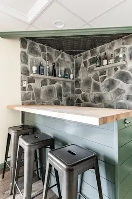 a bar with two stools and a stone wall at Waterfront Stagshead Lakehouse at Lake Arrowhead in Arrowhead Lake