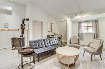 a living room with a couch and a table and chairs at 7 Mi to Whitewater Rafting Cozy Lansford Cabin! in Barnesville
