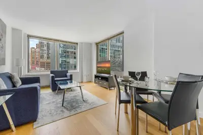 a living room with a table and a dining room at Global Luxury Suites at The Marc in New York