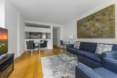 a living room with a blue couch and a table at Global Luxury Suites at The Marc in New York