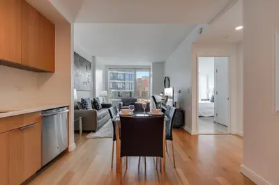 a kitchen and living room with a table in a room at Global Luxury Suites at Via 57 in New York