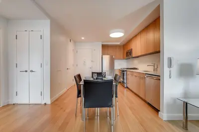 a kitchen with a table and chairs in a room at Global Luxury Suites at Via 57 in New York