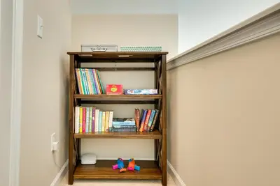 a book shelf with books and toys in a room at Hike and Ski Pocono Lake Home with Community Perks! in Pocono Lake