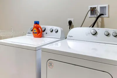 a washing machine with an orange bottle on top of it at Hike and Ski Pocono Lake Home with Community Perks! in Pocono Lake