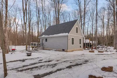 a small house in a yard with snow on the ground at Hike and Ski Pocono Lake Home with Community Perks! in Pocono Lake