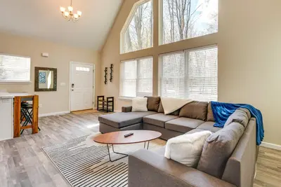 a living room with a couch and a table at Hike and Ski Pocono Lake Home with Community Perks! in Pocono Lake