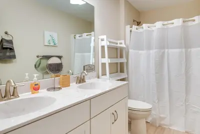a white bathroom with a sink and a toilet at Hike and Ski Pocono Lake Home with Community Perks! in Pocono Lake