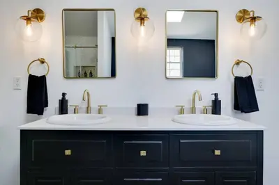 a bathroom with two sinks and two mirrors at Luxe Lrg Pocono House for 18 Hot Tub/Gameroom/Pool in Kunkletown