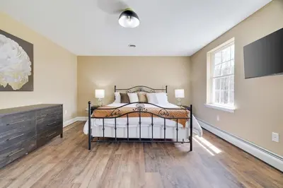 a bedroom with a bed and a large window at Luxe Lrg Pocono House for 18 Hot Tub/Gameroom/Pool in Kunkletown