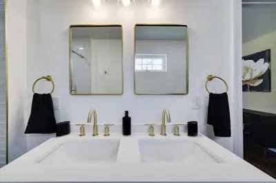 a white bathroom with two sinks and two mirrors at Luxe Lrg Pocono House for 18 Hot Tub/Gameroom/Pool in Kunkletown