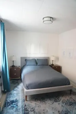 a bedroom with a bed with two night stands and two lamps at Charming Victorian Home In Historic District in Newburgh