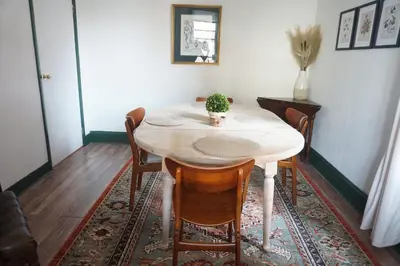 a dining room table with a potted plant on it at Charming Victorian Home In Historic District in Newburgh