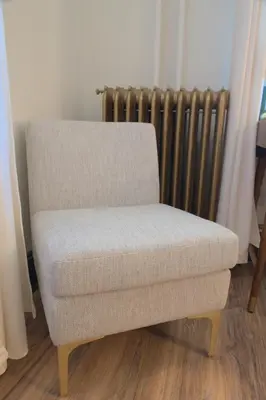 a chair sitting in a room with a radiator at Charming Victorian Home In Historic District in Newburgh