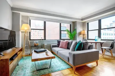 a living room with a couch and a tv at Midtown E Studio w Great light Gym NYC-139 in New York