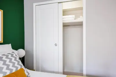 a bedroom with green walls and a white closet at Midtown E Studio w Great light Gym NYC-139 in New York