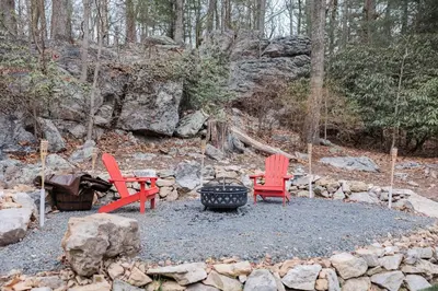 two red chairs and a fire pit in a yard at Cowry Acres - 11 Acre Enchanted Retreat, Hot Tub in New Hope