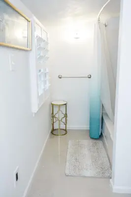 a bathroom with a blue shower and a rug at Cowry Acres - 11 Acre Enchanted Retreat, Hot Tub in New Hope