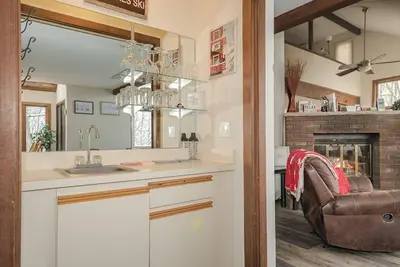 a kitchen with a chair and a fireplace at Camelback Condo in Tannersville