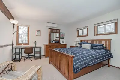 a bedroom with a bed and a desk and a chair at Camelback Condo in Tannersville