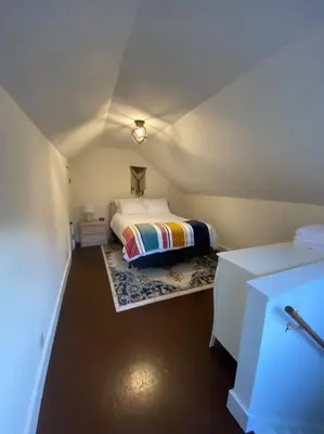 a small bedroom with a bed in a room at Chic Catskills Getaway Bungalow in Hurleyville