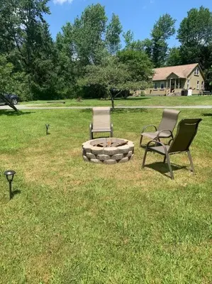 two chairs and a fire pit in a yard at Chic Catskills Getaway Bungalow in Hurleyville
